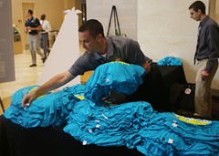 Chris Mitchell and Jeremy Rosental organizing race shirts for the 5K Fun Run/Walk presented by CTVT and ProForma.